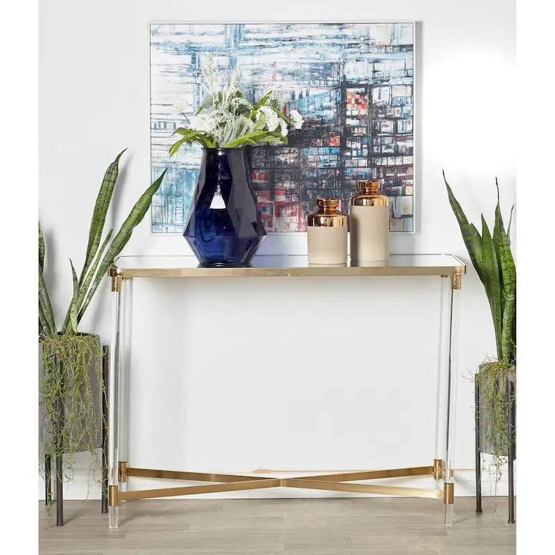 Table d'entrée en métal avec plateau miroir et pieds en acrylique.