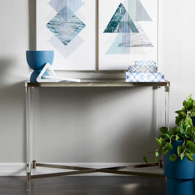 Table d'entrée en métal avec plateau miroir et pieds en acrylique.
